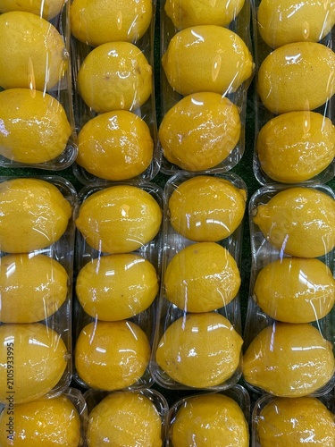 Quadro su tela The selected image shows lemons packed individually into small, clear plastic trays and wrapped, commonly found in supermarkets to retain moisture and prevent bruising