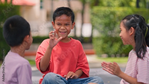 Bild auf Leinwand Happy Asian children playing traditional games together in park outdoor