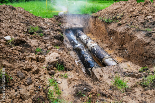 Konstfotografi Exposed heating pipelines in open trench after utility failure
