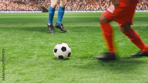 Cuadro en lienzo A red soccer player falls to the grass in pain after a dangerous tackle as teammates protest and demand a foul sanction, creating a dramatic injury moment while the footballer rolls on the pitch