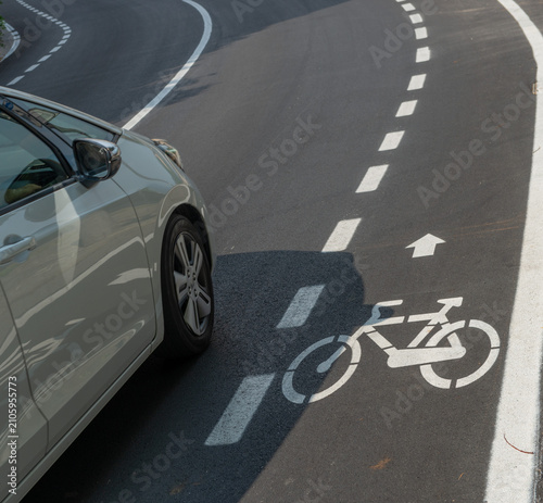Cars driving next to a cycle path