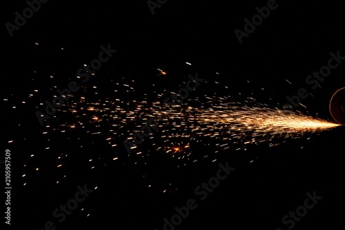 Flying Sparks from Cutting Disc on Black Background