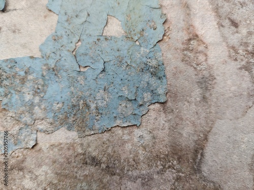 A distressed wooden surface featuring random peeling paint, chipped layers, cracks, scratches, and naturally weathered wood grain. The irregular worn texture creates a rustic, vintage, and aged appear