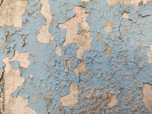 A distressed wooden surface featuring random peeling paint, chipped layers, cracks, scratches, and naturally weathered wood grain. The irregular worn texture creates a rustic, vintage, and aged appear
