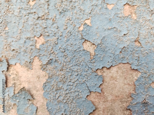 A distressed wooden surface featuring random peeling paint, chipped layers, cracks, scratches, and naturally weathered wood grain. The irregular worn texture creates a rustic, vintage, and aged appear