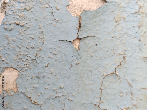 A distressed wooden surface featuring random peeling paint, chipped layers, cracks, scratches, and naturally weathered wood grain. The irregular worn texture creates a rustic, vintage, and aged appear