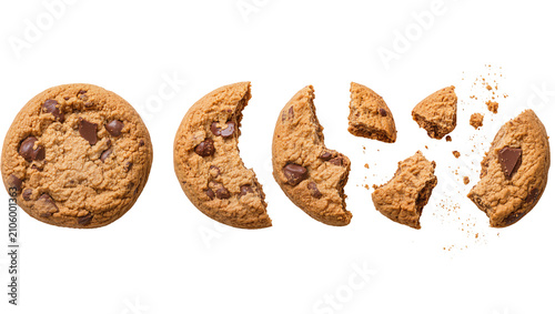 Isolated delicious chocolate chip cookie whole and breaking into pieces with crumbs flying