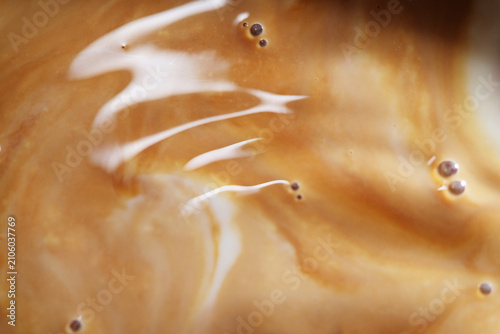 Close up of milk on black tea