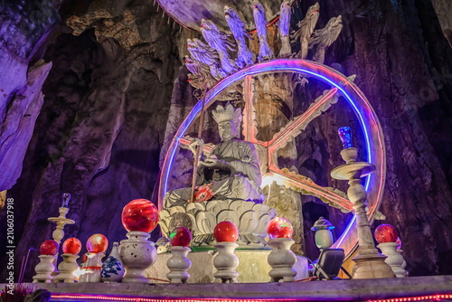 Photos Sacred stone statue with neon wheel of dharma and naga guardians inside the myst