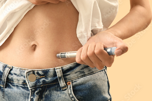 Person injecting insulin in...