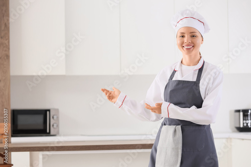Smiling female chef in unif...