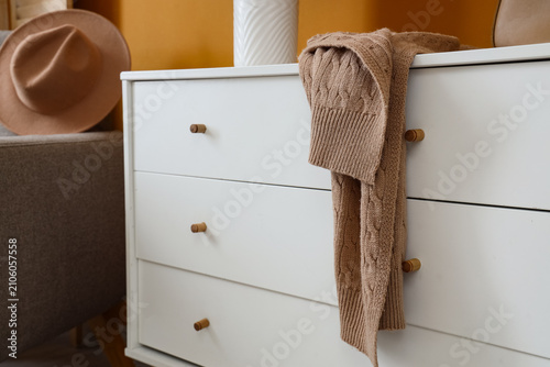 Warm scarf on chest of draw...