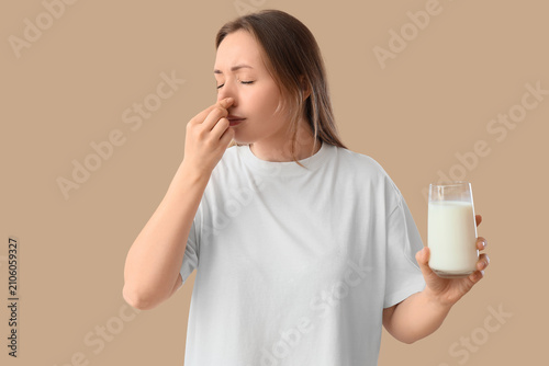 Young woman with glass of m...