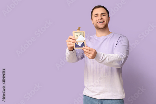 Young happy man holding wal...