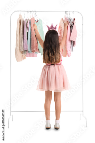 Cute little girl near rack ...