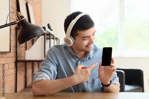 Young man with headphones p...