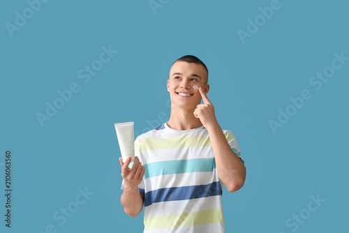 Happy young man with bottle...