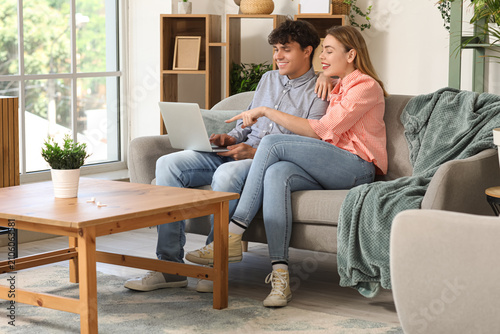 Young couple with laptop sh...