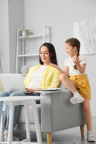Working mother with her lit...