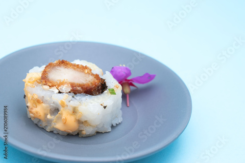 Japanese sushi rolls on blue background with copy space
