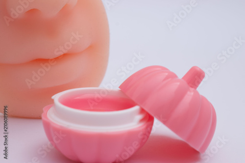 Pink lipstick with daisy flower on pastel background