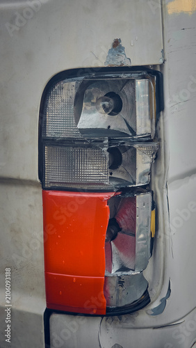 The rear tail light is damaged. The lens is cracked, the body panel is dented, and the rear bumper is scratched.