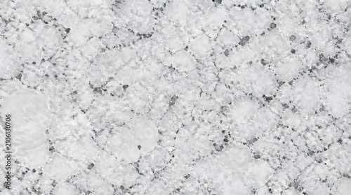 Close up view of a textured grey stone surface with intricate natural patterns.