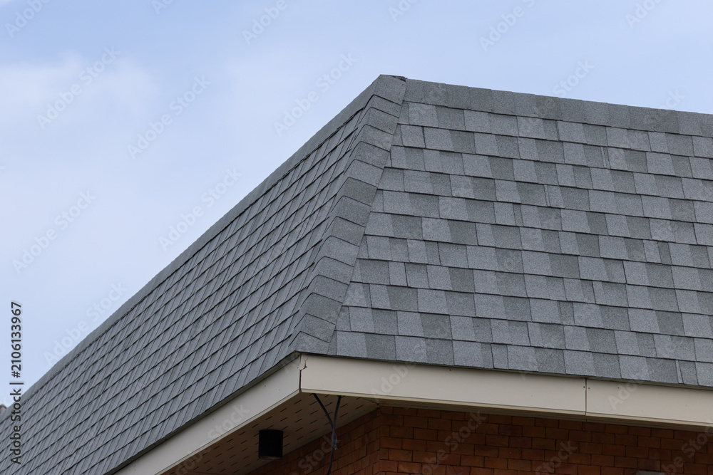 Fototapeta premium Close-up view of gray asphalt shingles on residential roof
