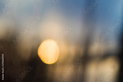 Photography Blurry golden sunset background with warm bokeh light.