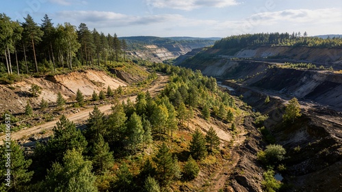Aerial view of open pit mine and reforestation valley ideal for environmental restoration land recovery and industrial ecology presentation