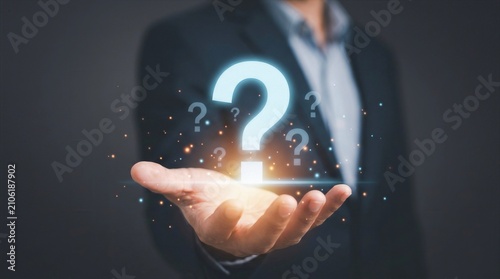 Businessman holding glowing question mark symbol concept for problem solving and FAQ