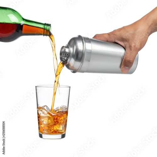 Liquor pouring from bottle and shaker into iced glass isolated white background
