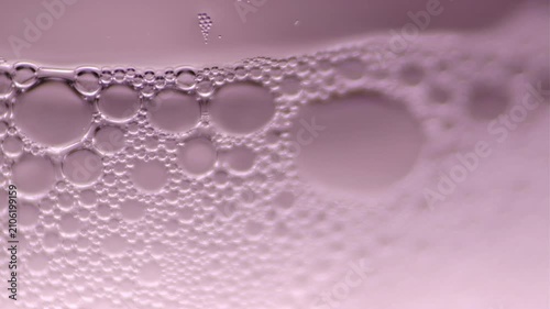 Macro footage of soap bubbles in glass container