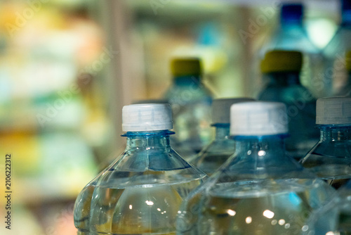 A Close-Up View of Water Bottles in a Refrigerated Display, Highlighting Their Clear Design and Cap Features in an Organized Arrangement.