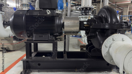 Obraz na plátne Industrial centrifugal water pump powered by heavy duty electric motor with steel pipeline system for water treatment, manufacturing plant, and engineering facility maintenance