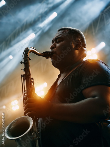 Soulful Jazz Musician Immersed in Melodic Performance, Capturing the Essence of Rhythm and Passion in Intimate Club Setting