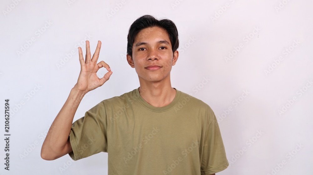 Naklejka premium handsome asian young man showing okay gesture