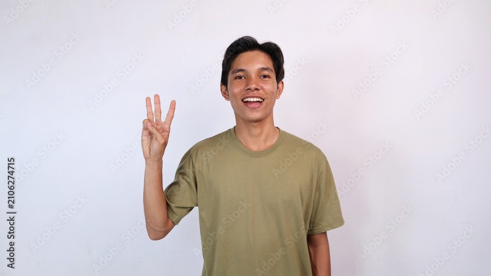 Naklejka premium Asian young man showing number three gesture