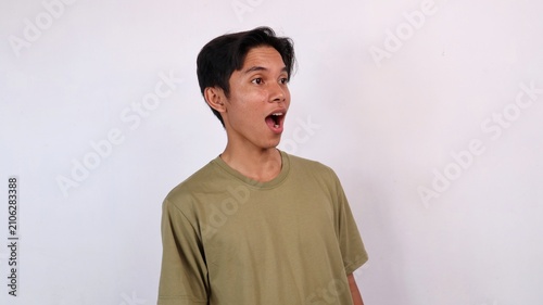Photos shocked asian young man opening his mouth