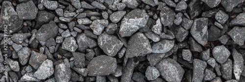 Rough texture background displaying many grey stones and natural gravel