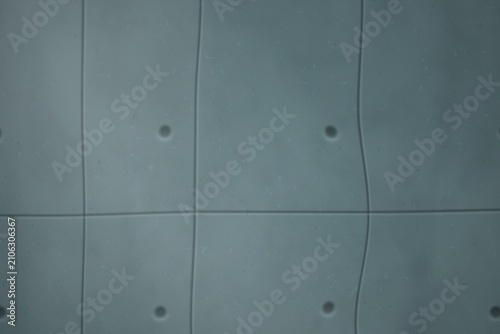 Εκτύπωση καμβά Gray concrete wall with grid pattern and circular indentations