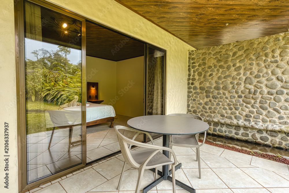 Fototapeta premium Resort patio overlooking tropical nature from a bedroom