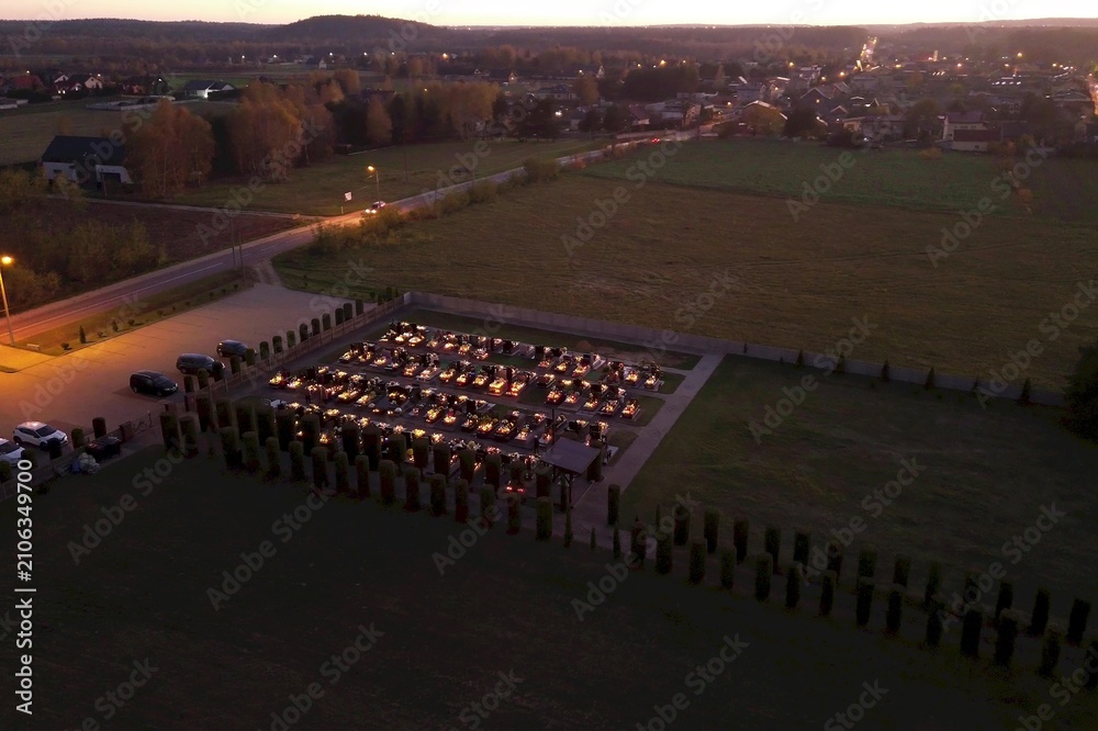 Fototapeta premium Night cemetery glowing with candles honoring Polish tradition