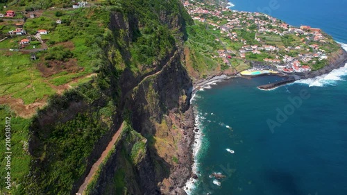 Ponta Delgada Madeira Portugal Aerial Drone Flight Along Old Coastal Cliff Road ER101 Toward Scenic Village Peninsula Ocean Surge Waves Coastline Atlantic Travel Video 4K UHD