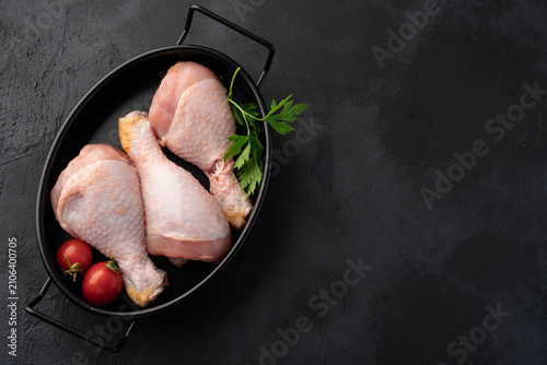 Raw chicken leg or drumstick isolated on black  background 