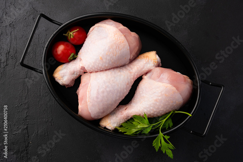 Raw chicken leg or drumstick isolated on black  background 