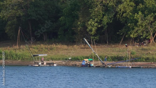 Traditional giant dip nets installed along the lake shore surrounded by green nature