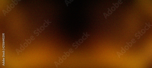 Fotografija Dark grainy texture background with soft abstract gradient of warm orange light