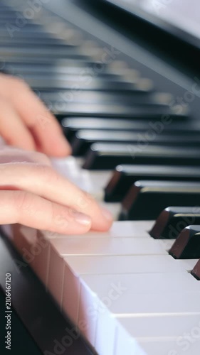Teacher and student playing the piano. Learning to play the piano. Close-up of hands and keys.