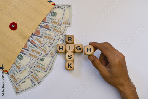 High risk concept with wooden blocks. Financial investment strategy and money management.